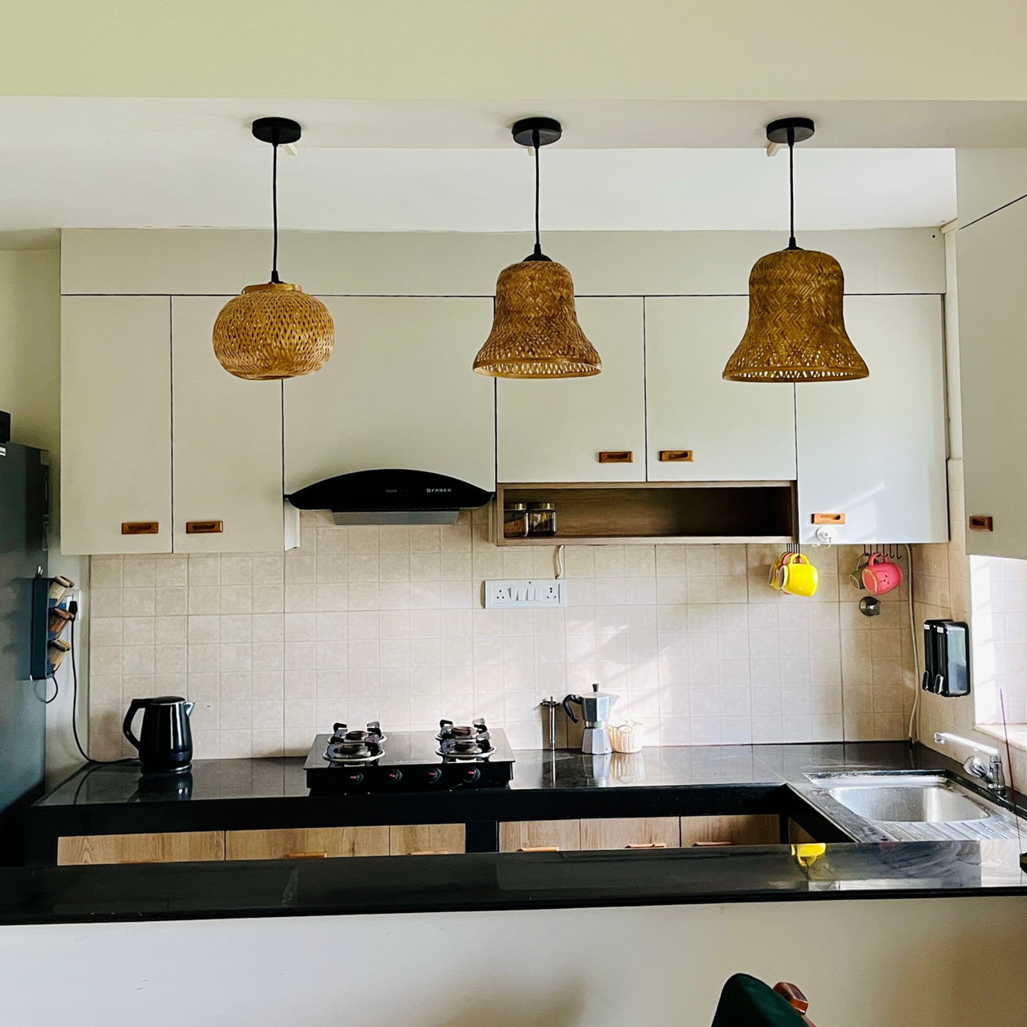Kitchen counter with woven pendant lights and morning coffee things