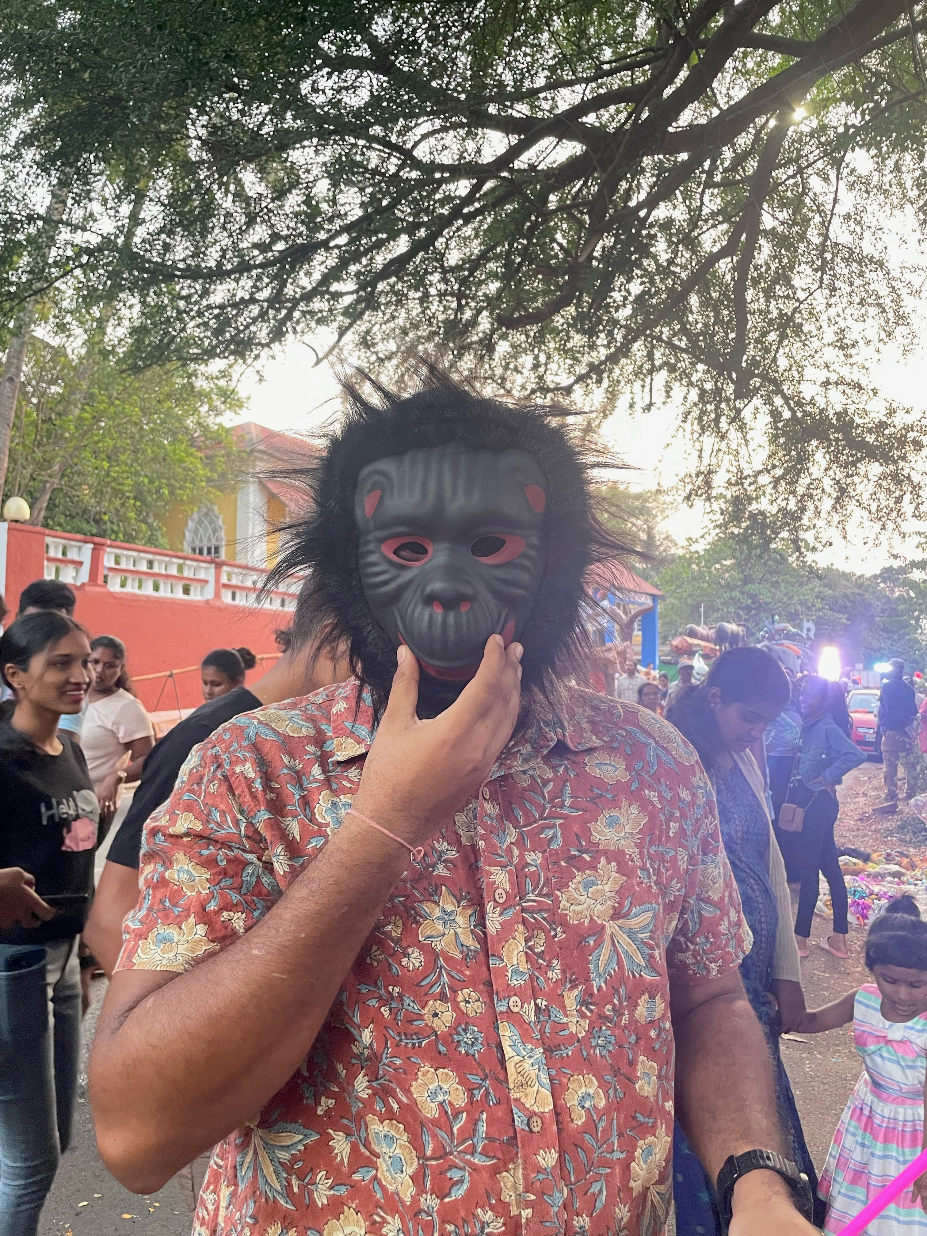 Garvit wearing a carnival mask under a tree